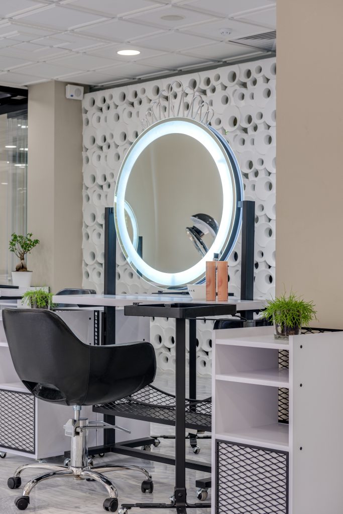 Elegant salon interior featuring a stylish setup with a ring light and mirror.